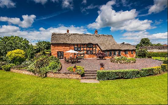 An enchanting grade II listed thatched farmhouse with outstanding views across Knighton Po