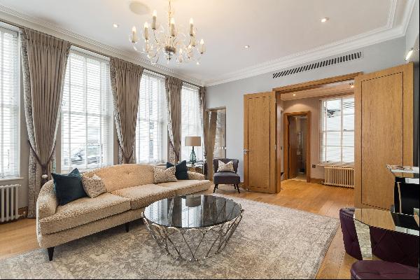 A stucco-fronted Freehold Belgravia house for sale with two bedrooms, located off of Eliza