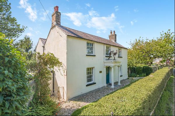 A late-Georgian house situated in a hamlet in about half an acre with unspoilt views of th
