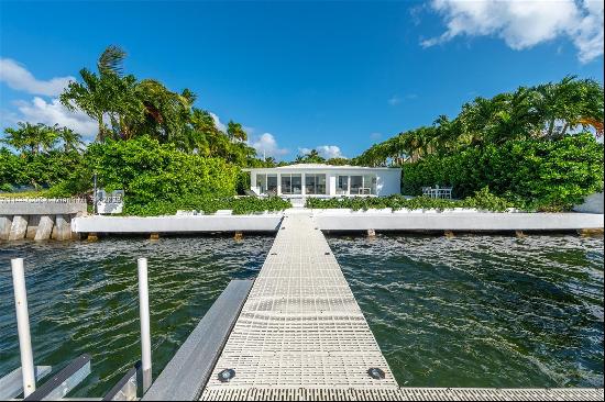 One-of-a-kind WIDE OPEN BAY sanctuary in the exclusive gated community of Normandy Shores.