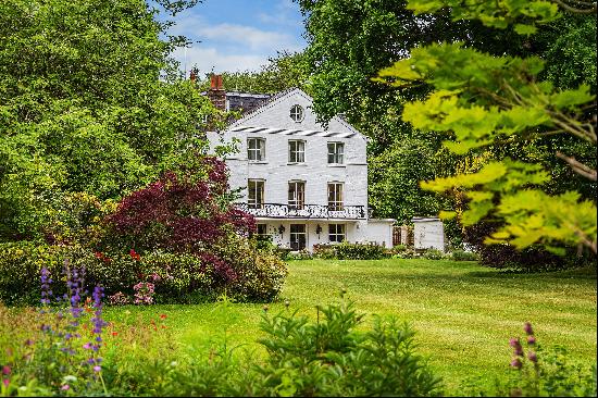 A truly sublime riverside country house adjoining the River Wey yet close to the centre of