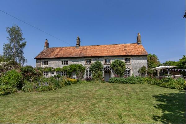 An attractive detached Grade II listed 5 bedroom family home, set in mature landscaped gar