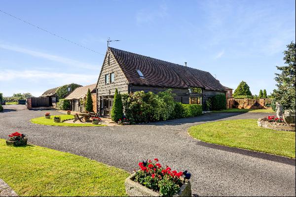 A superb barn conversion with a separate 2 bedroom cottage, outbuildings, heated swimming 