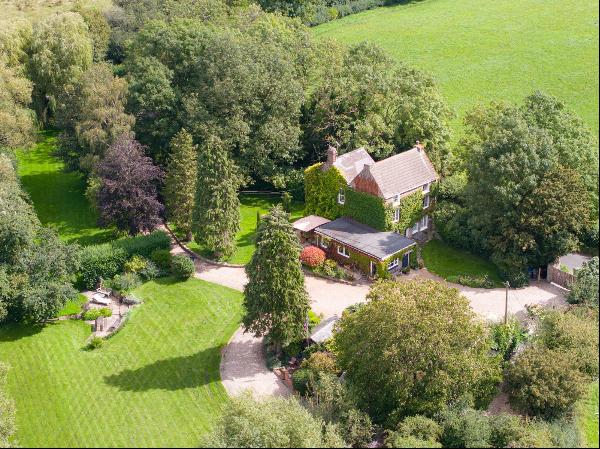 Country home with versatile outbuildings, land and views along private river valley close 