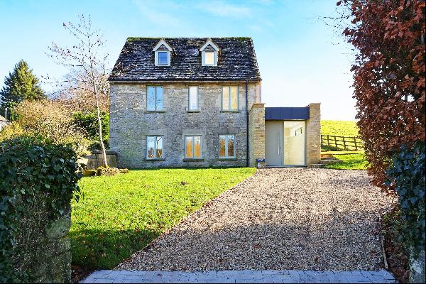 Located on the edge of the village with stunning far reaching views, a detached Cotswold s
