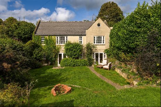A detached, five bedroom house, with garden, home office and parking in heart of Combe Dow
