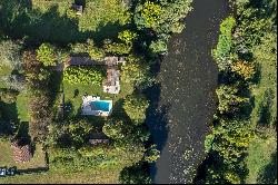 Property with multiple dwellings, pool, and river view