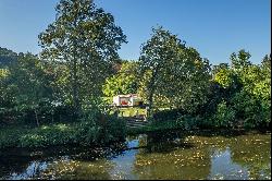 Property with multiple dwellings, pool, and river view