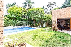 House  with a swimming pool inside a gated community