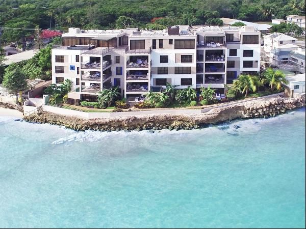 These quintessentially modern condominiums overlook a stunning bay on the South Coast, wit