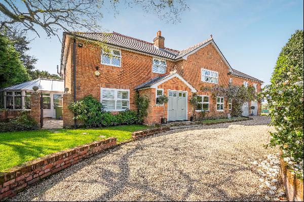 Superb family home set in three acres with heated outdoor pool and tennis court. 