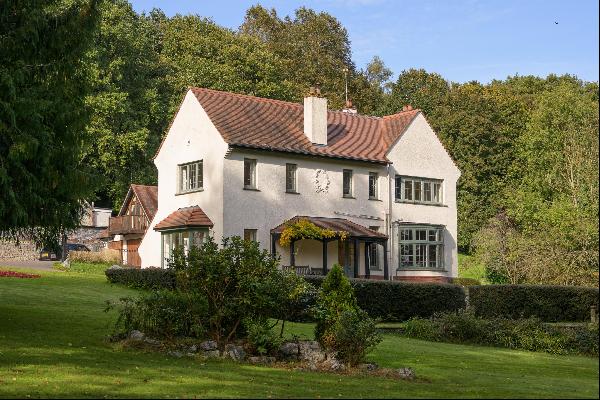 A substantial detached house, with ancillary accommodation, in park-like grounds with swee