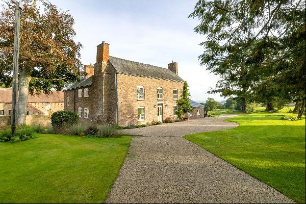 A beautifully renovated period farmhouse with a range of outbuildings and paddocks set in 