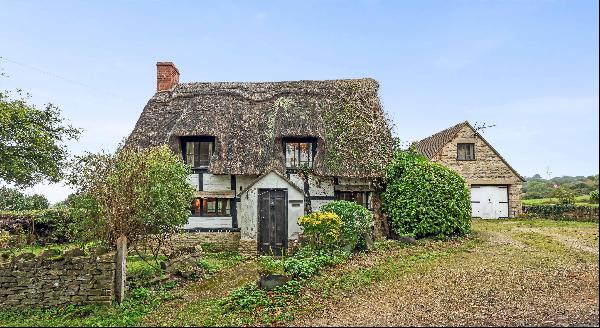Located close to Prescott Hill Climb, a pretty thatch cottage in need of modernisation