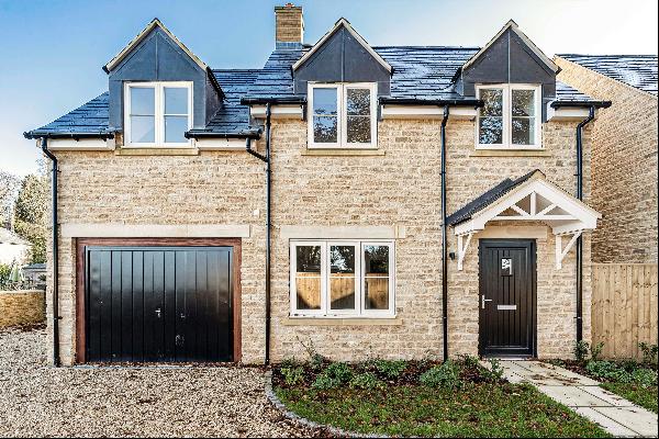 An exceptionally well-designed new detached Cotswold stone house with a high-spec finish a