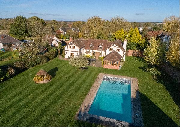 A five bedroom cottage with detached pool house and annexe, set in 1.5 acres.