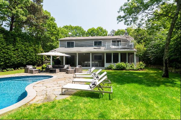 Located less than three miles from East Hampton village in the Northwest Woods sits this s