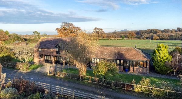 A spacious Grade II listed barn conversion located in a popular village enjoying far reach