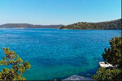 Seafront plot with a project near Trogir