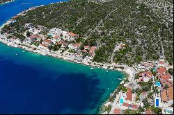 Seafront plot with a project near Trogir