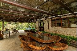 House in the mountains with a water spring and a helipad