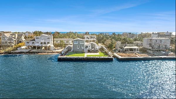 Nestled in the heart of Westhampton Beach, this turnkey bayfront property offers an idylli