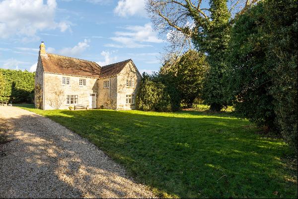 A historic Grade II listed house with mature gardens in this private location.