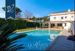 Luxurious villa for sale in Casal Palocco, an exclusive neighbourhood of Rome, offering a 