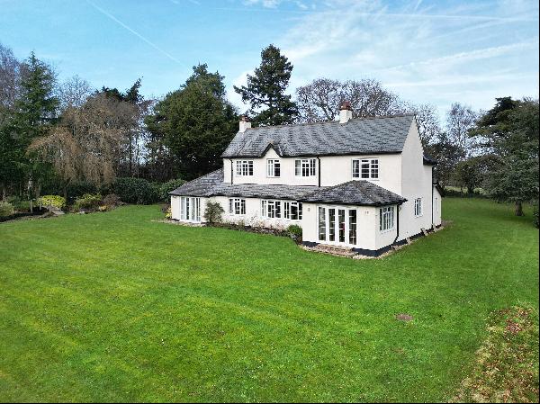 A charming, detached country home sat within approximately 4 acres of landscaped gardens a