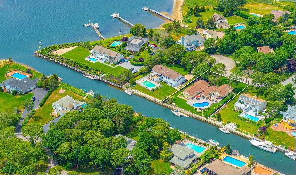 Located within the exclusive Old Harbor Colony Community in Hampton Bays, this stunning wa