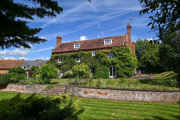 A charming 19th century farmhouse, cottage and outbuildings with land in Herefordshire's b