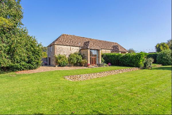 An impressive Grade II Listed 18th century barn, with large gardens, a double garage and s