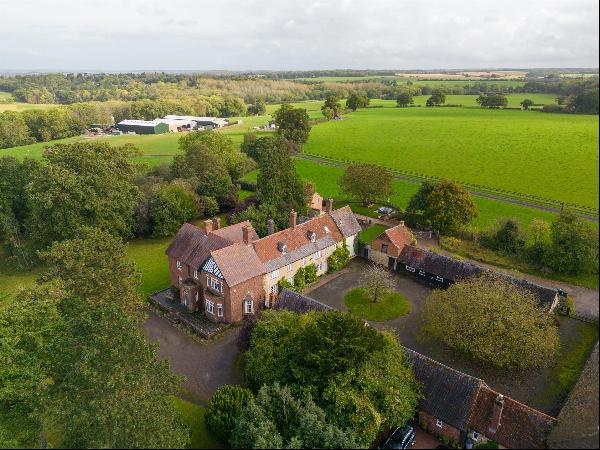 A superbly located country house in a beautiful setting with large mature gardens, tennis 