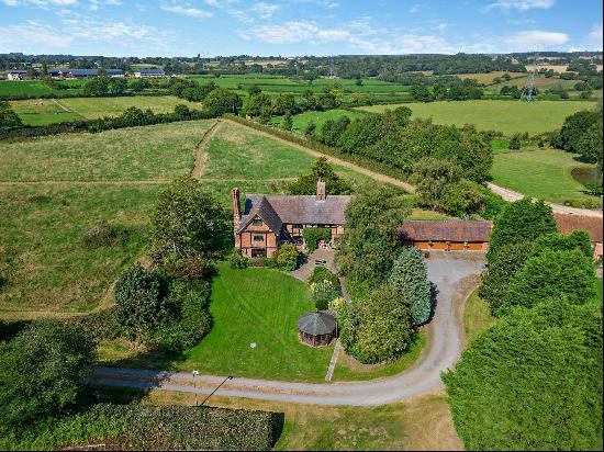 A Tudor farmhouse in an idyllic location with a separate annexe and multiple outbuildings 