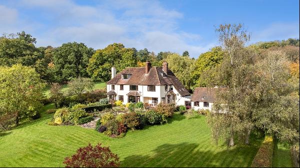 A spacious 1920's country house with far reaching views set in 9.3 acres of beautiful gard