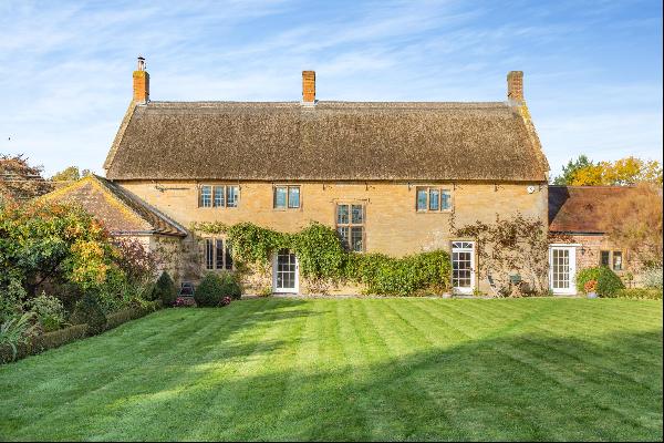 A fine 17th century village house with annexe, outbuildings and large garden backing onto 