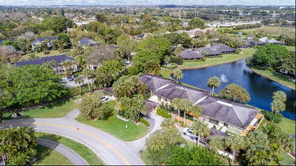 This waterfront villa, situated in the prestigious Palm Beach Polo community, features ove