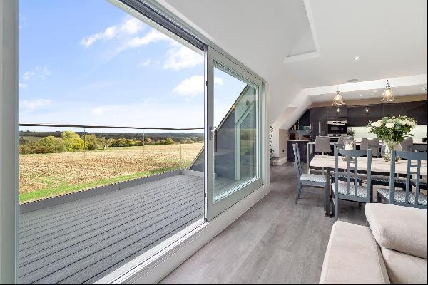 This modern contemporary penthouse apartment with incredible views across the Windrush Val