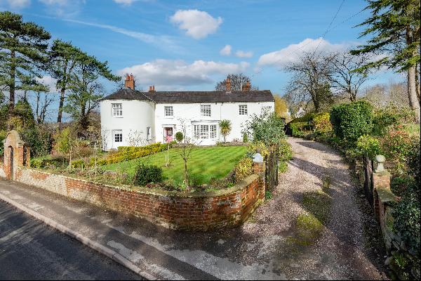 A beautiful Grade II listed period property with a substantial range of outbuildings and w