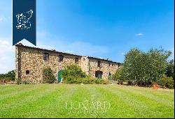 Charming agritourism resort with organic vineyards and olive groves for sale in Tuscany