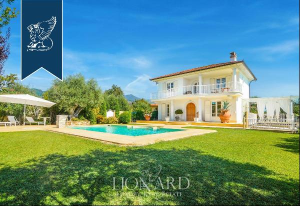 Elegant villa with an outbuilding and big private garden for sale on the Tuscan coast