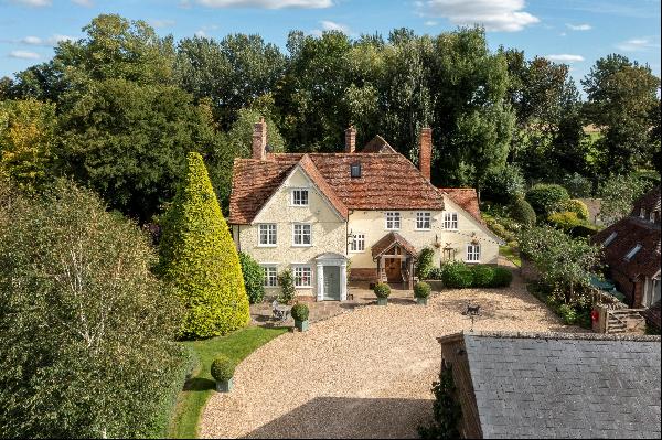 A period house with land, a separate cottage, swimming pool, tennis court and lake.