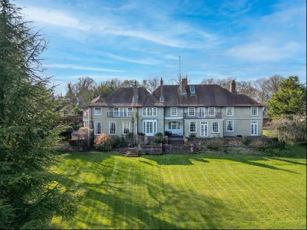 A substantial Edwardian house with river frontage on the Thames, and far-reaching views.