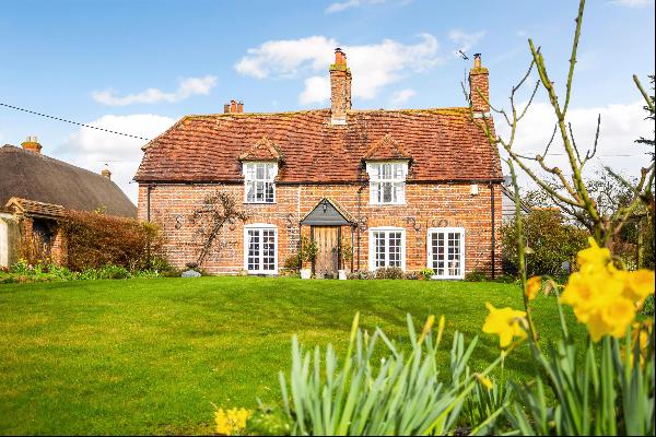 A charming village house with separate cottage, large period barn and pretty garden.
