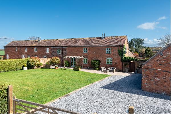 A beautifully appointed barn with superb ancillary accommodation found in a delightful vil