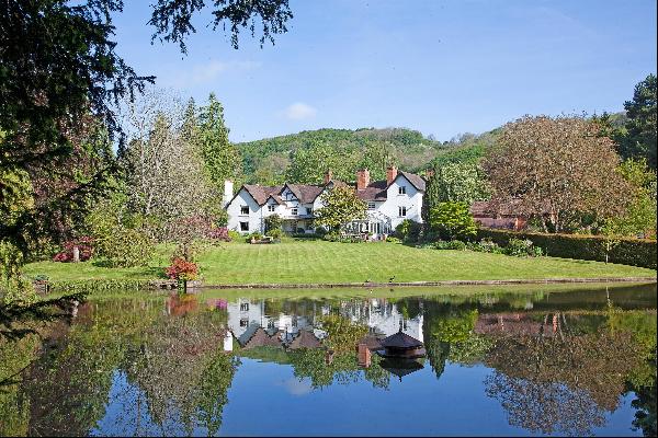 A listed Country House, with annexe and outbuildings, overlooking its own two acre lake an