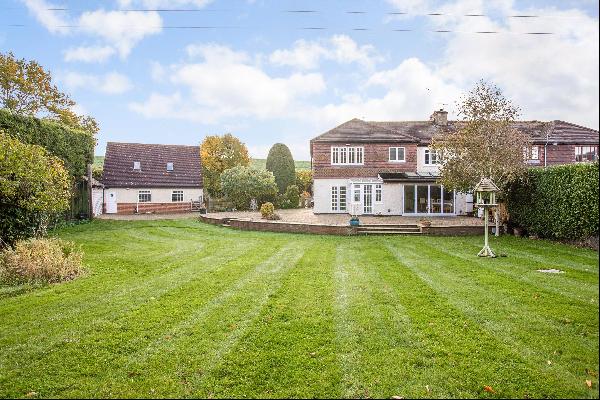 A superb family home with a garage/workshop, annexe, gym and outbuildings, set within a de