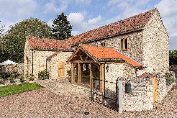 A stunning bespoke stone-built barn conversion with adjoining paddock, detached garage and