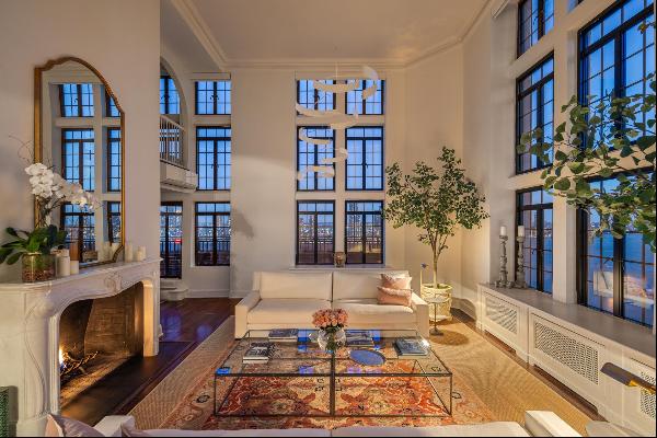 Step into this extraordinary penthouse, featuring soaring 18-foot ceilings and 19 triple-h