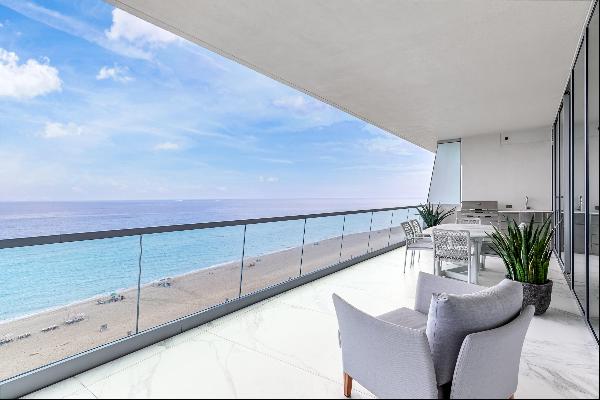 This stunning beachfront corner residence with a modern flair, offers a luxury lifestyle o